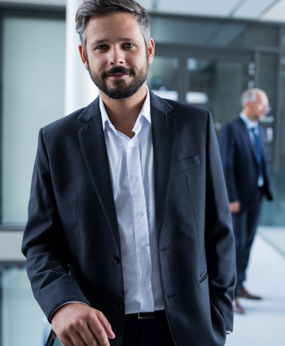 businessman-standing-in-office-corridor-and-collea-2023-11-27-04-54-08-utc